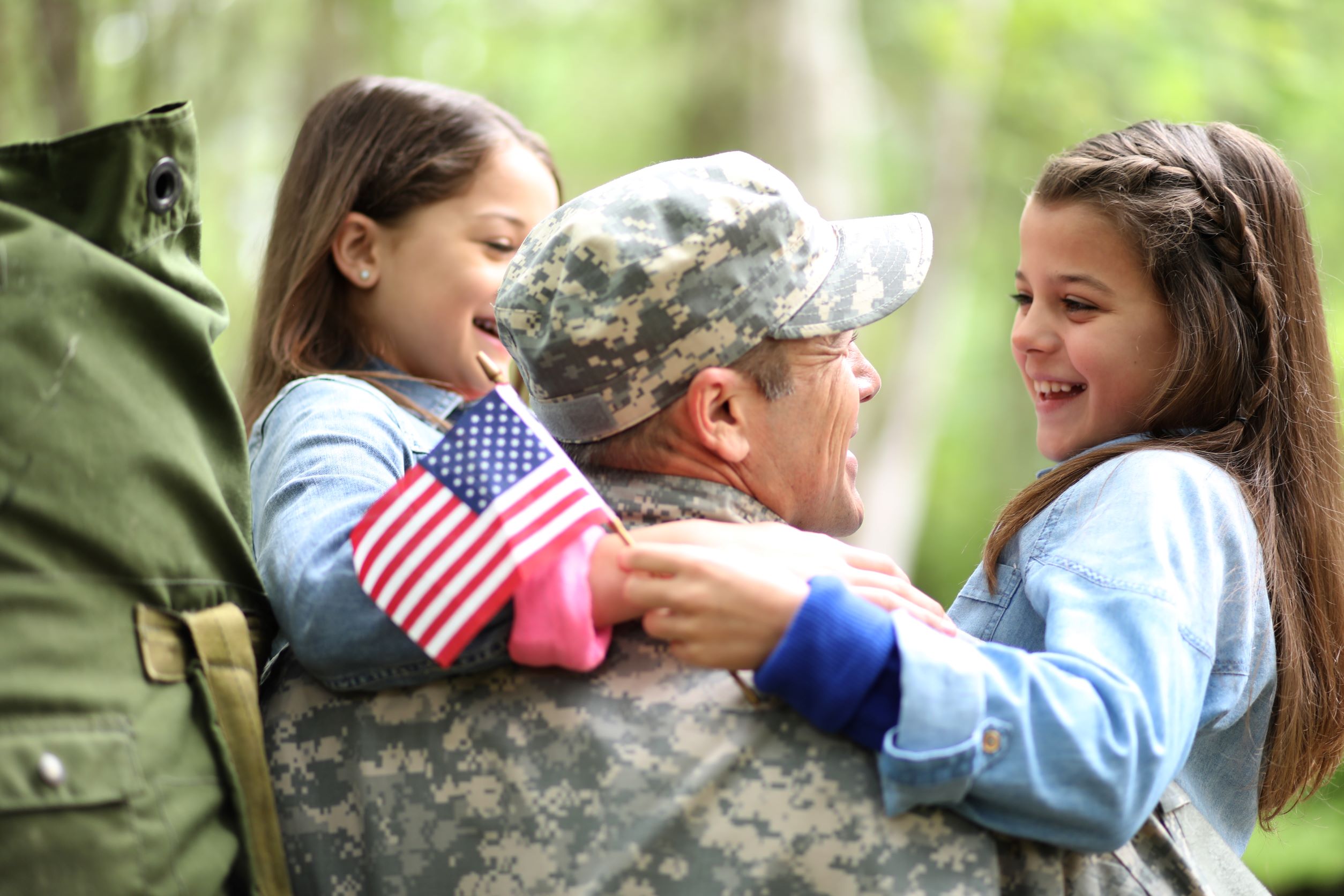 Military member holding his kid.