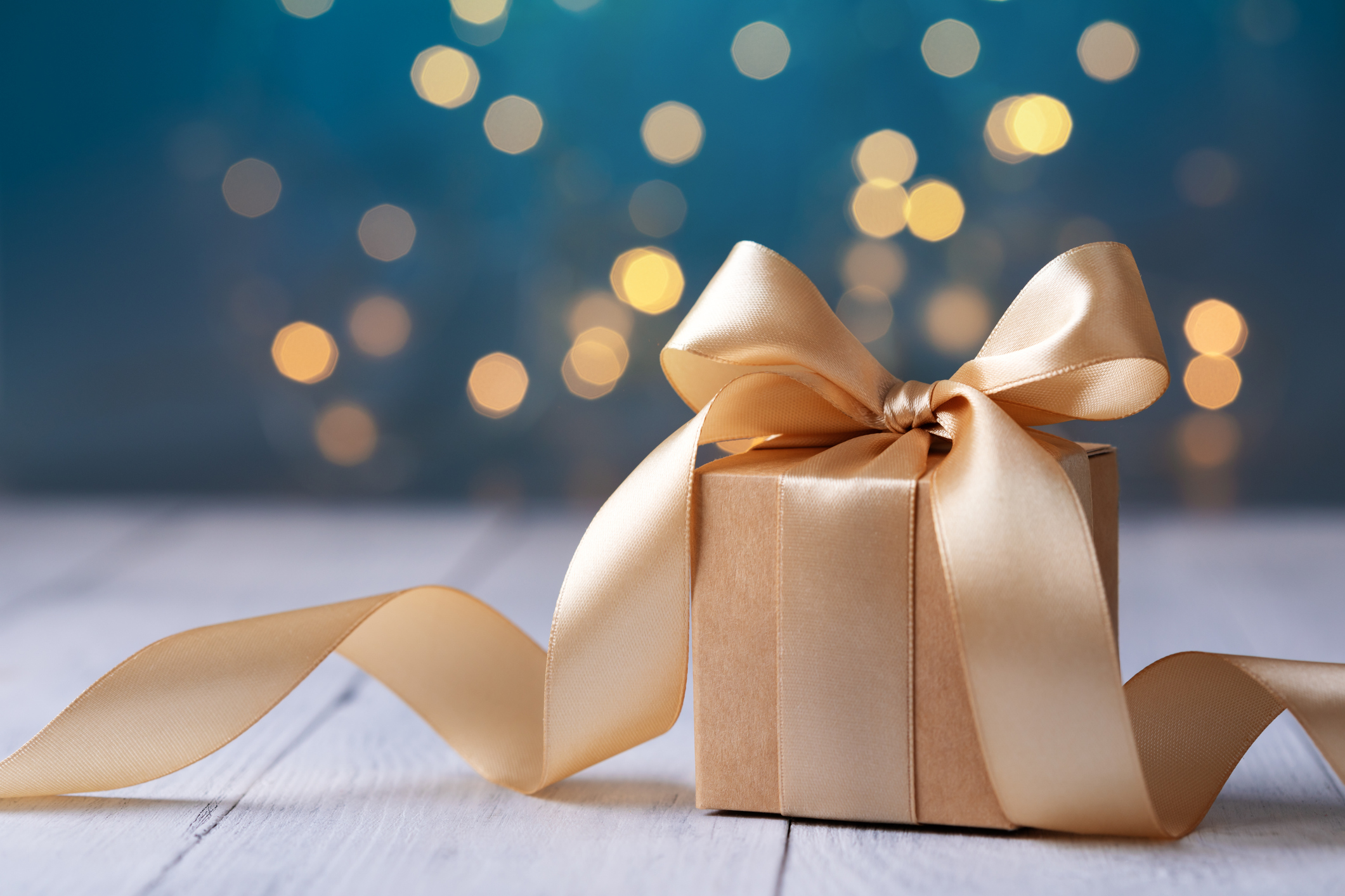 Present sitting on a table with a bow