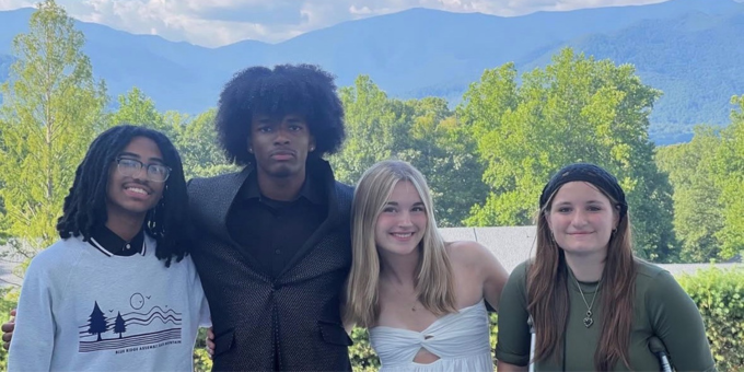 four teens smiling at the camera
