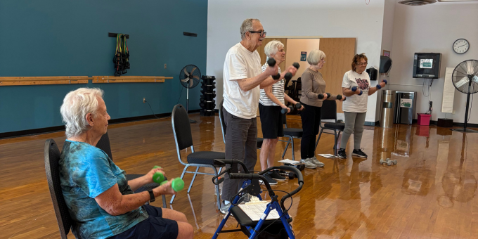 group of seniors sitting down in an exercise class