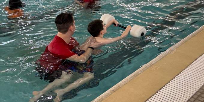 image of a swim instructor teaching swim lessons