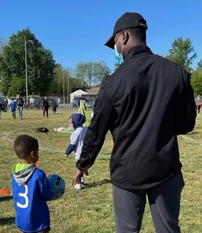 LA and little boy with a soccer ball
