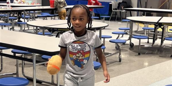 little boy in a cafeteria having fun
