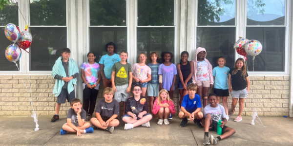 group of children outside of a school