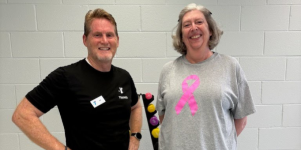 trainer and woman smiling at the camera