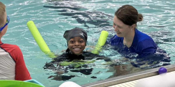 swim instructor swimming with a child
