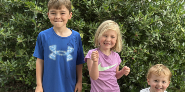 group of three children smiling