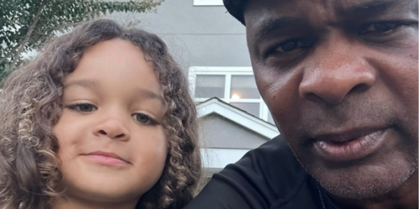 a man and his son infront of the camera