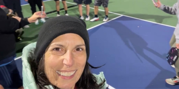 women smiling on a pickleball court
