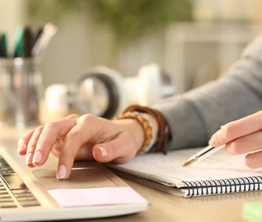 Women with a pen and computer
