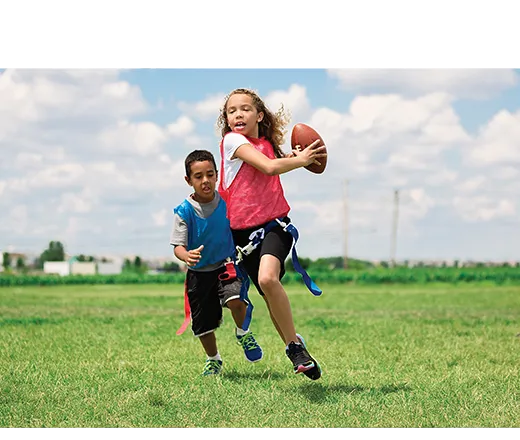 Girl and boy playing flag football