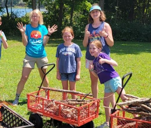 kids and councilor with sticks in wagon