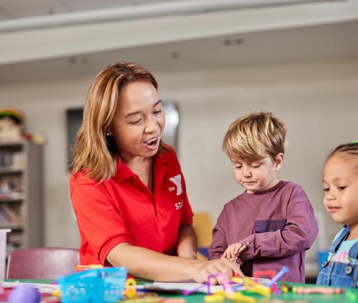 Volunteer doing activity with child.