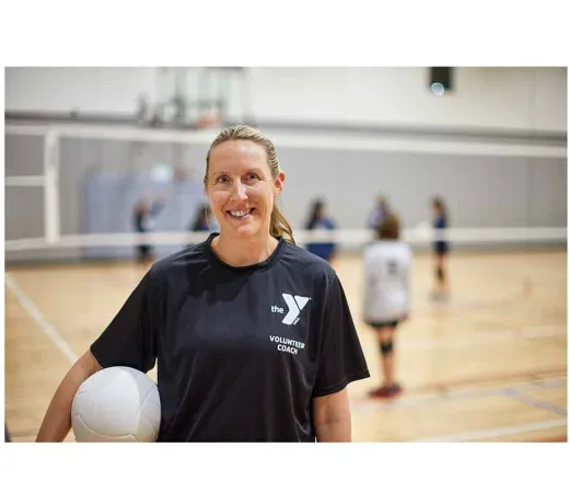 Coach holding volleyball