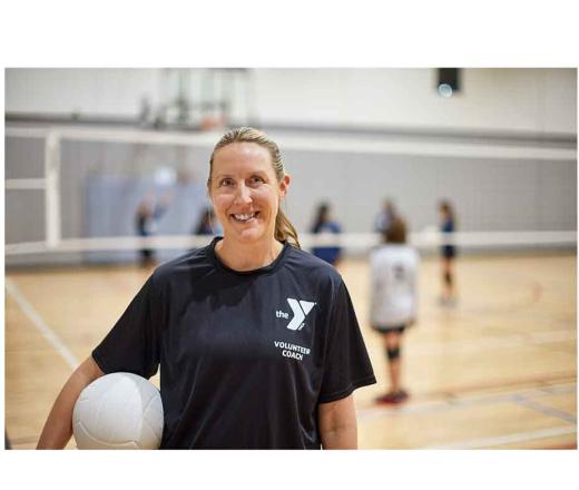 Coach holding volleyball