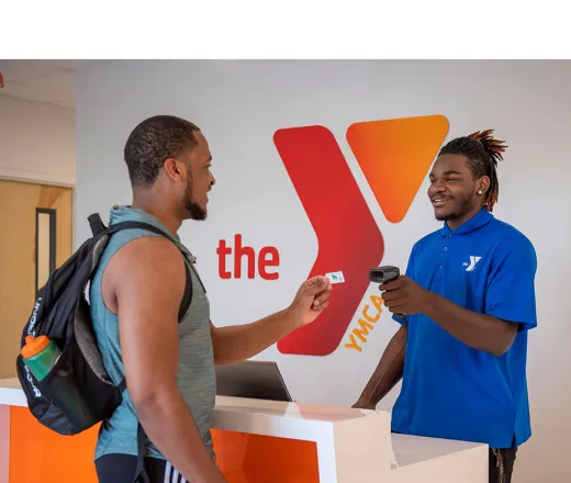 Two members scanning into the YMCA at the front desk