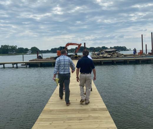Two people walking down a dock.