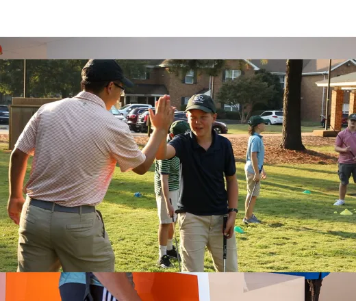 Two golfers high fiving.