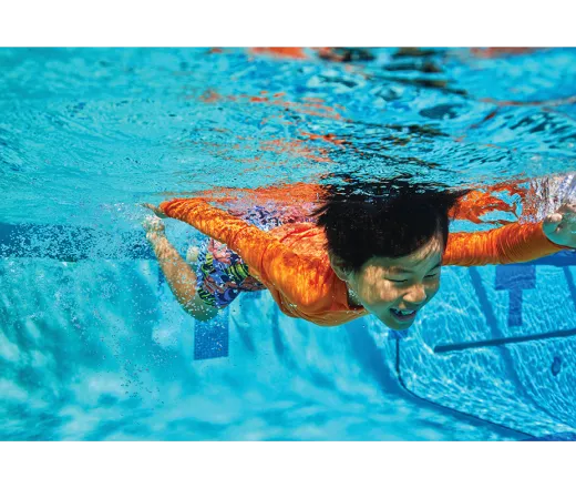 Kid swimming under water.