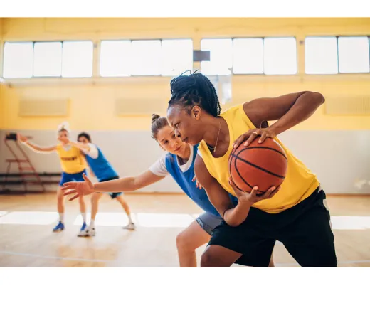 Adults playing basketball