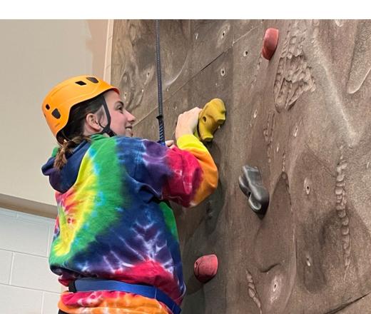 Person climbing rock wall