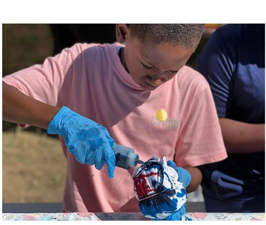 boy tie dying a shirt