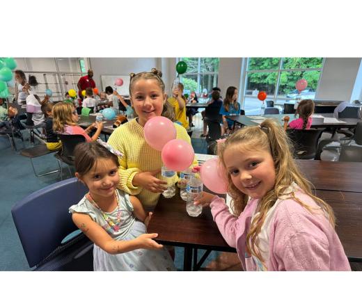 kids sitting around the table smiling