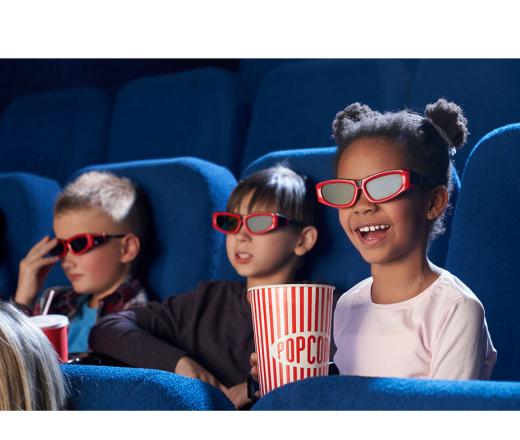 kids watching a 3D movie with popcorn