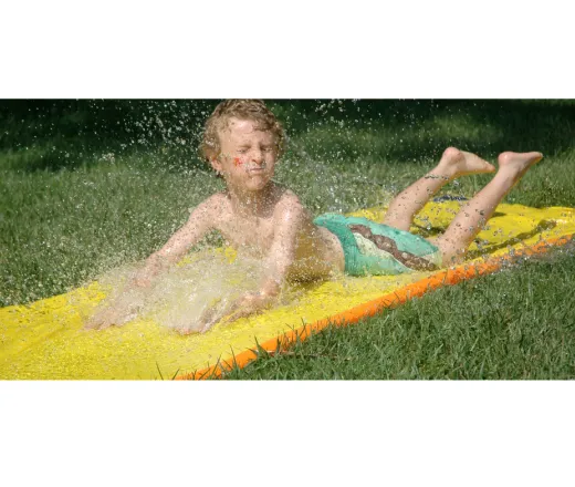 kid going down a slip and slide