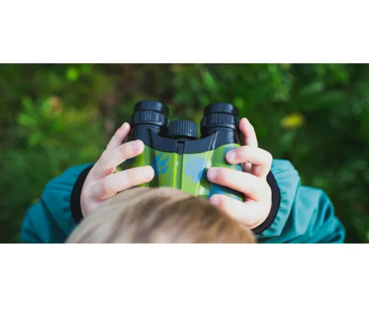 little boy looking through binoculars