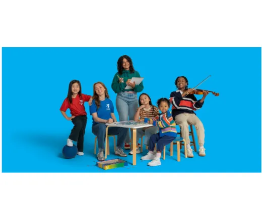 group of students sitting and smiling at camera
