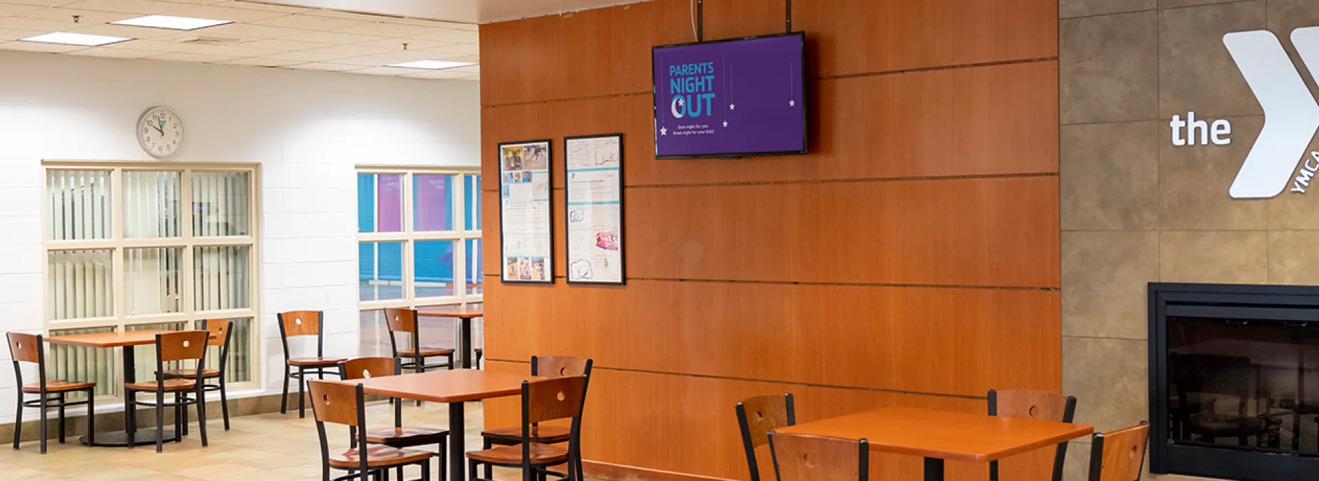 Lobby with chairs and tables and a TV