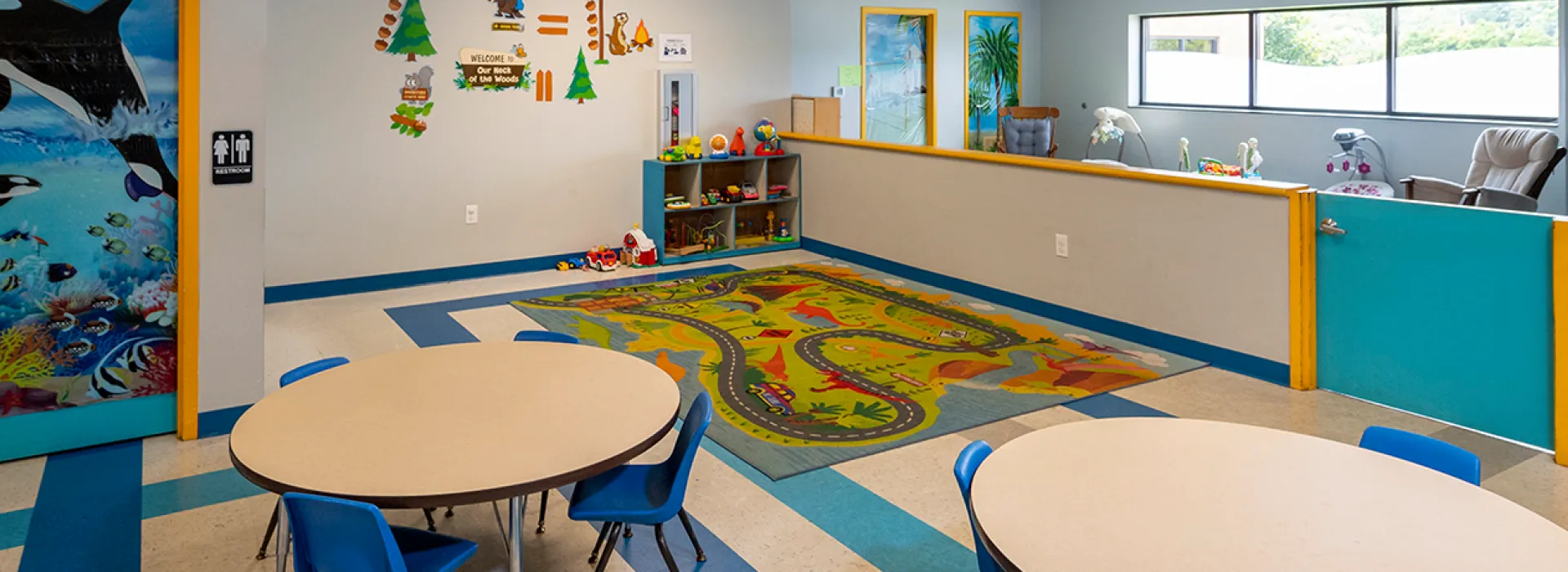 Child Watch room with tables and toys for children.