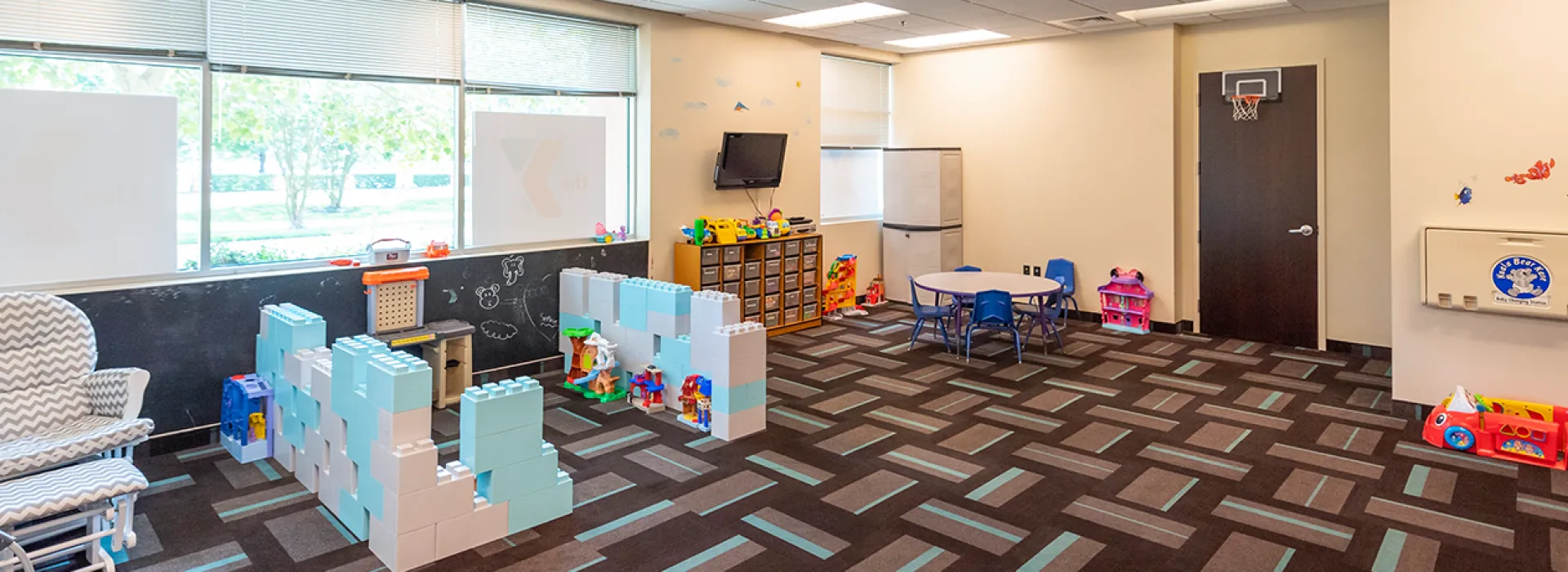 Child Watch area with toys for kids to play with