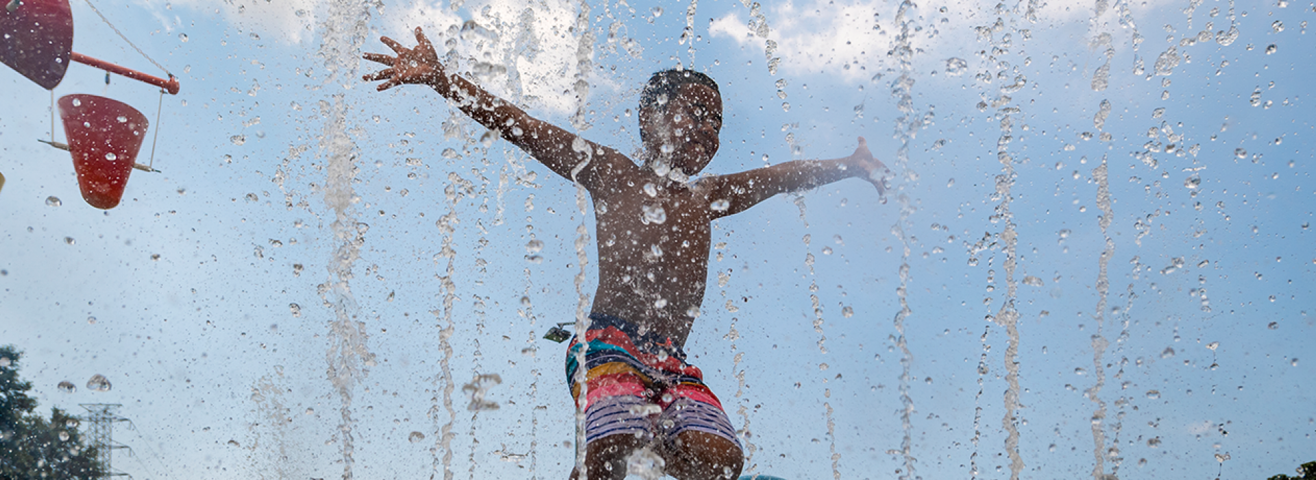 Child running around in the water at the splash park