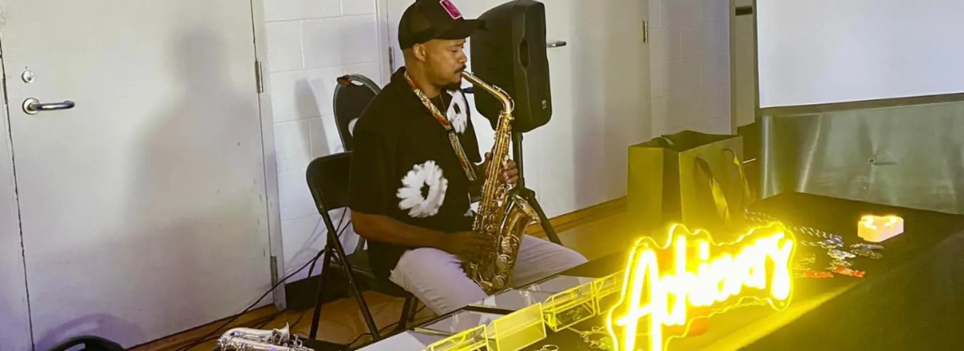 Man playing instrument at Y Achievers meeting